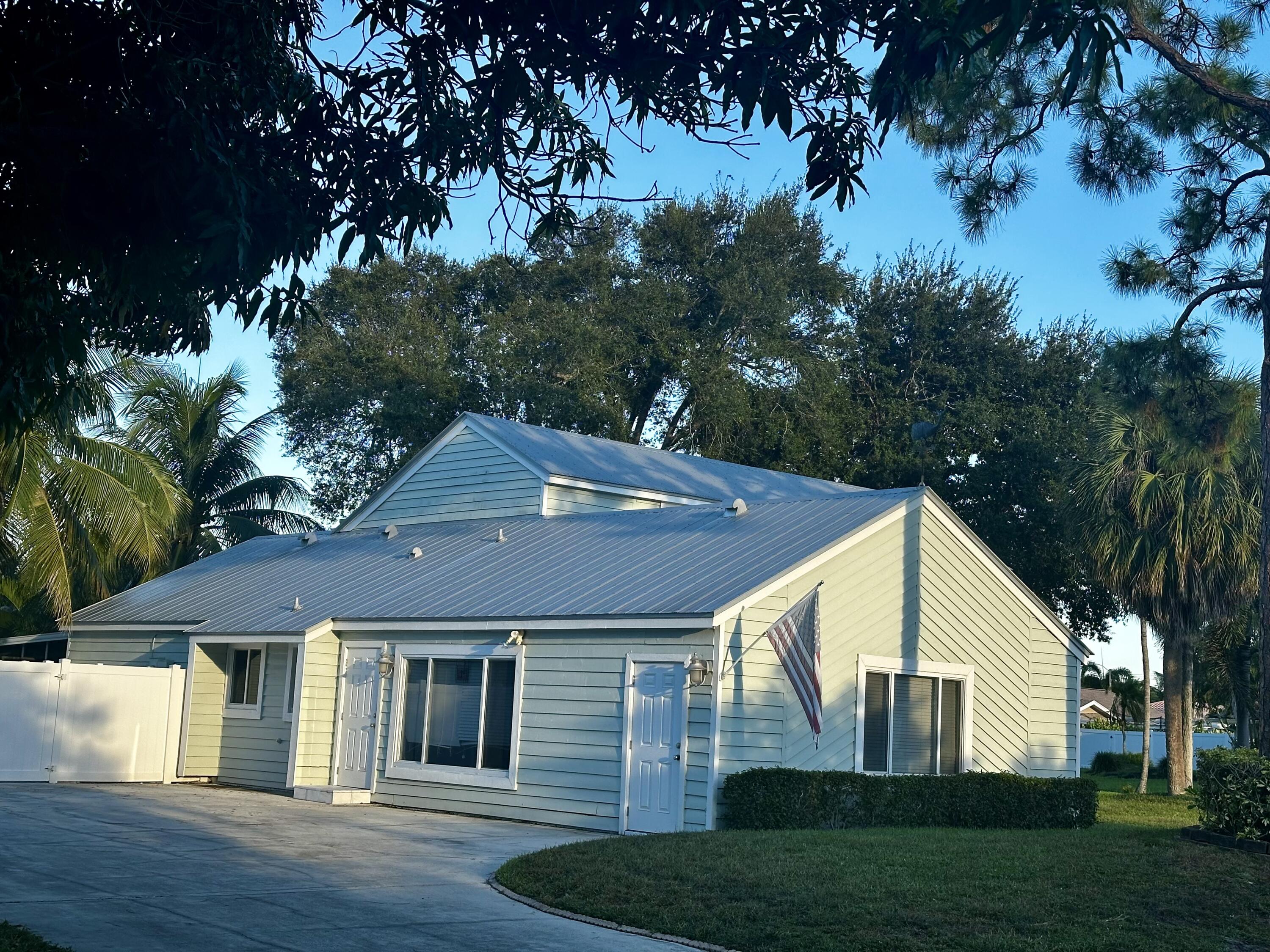 198 Southwest 15th Court Boca Raton, FL 33486 - Photo 2 of 2 a front view of a house with a yard