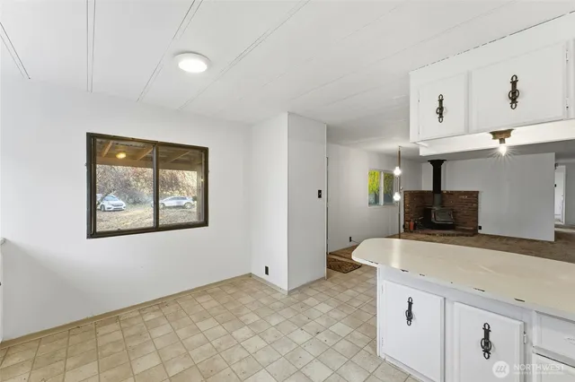 a kitchen with stainless steel appliances a cabinets and a window