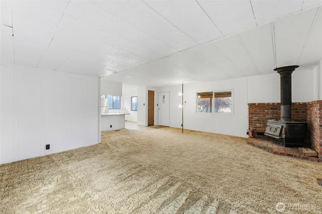 a view of an empty room with a fireplace