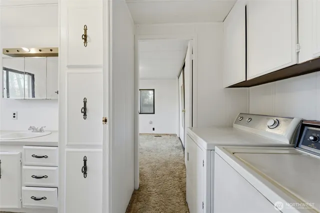 a utility room with closet dryer and washer