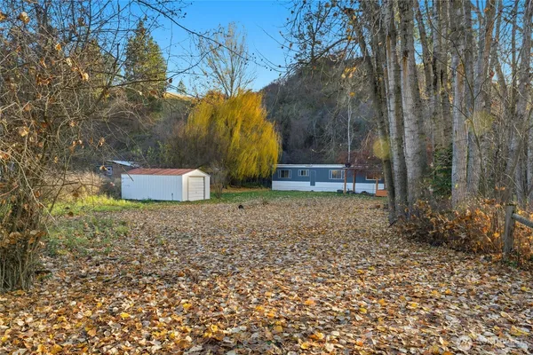 a backyard of a house with a yard and outdoor seating