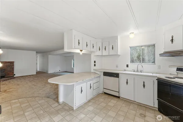 a kitchen with a sink stove and cabinets