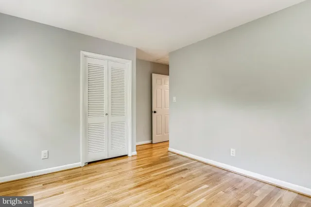 a view of an empty room and wooden floor