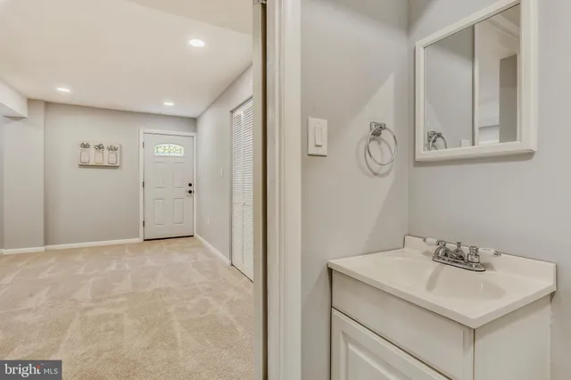 a bathroom with a sink vanity and a mirror