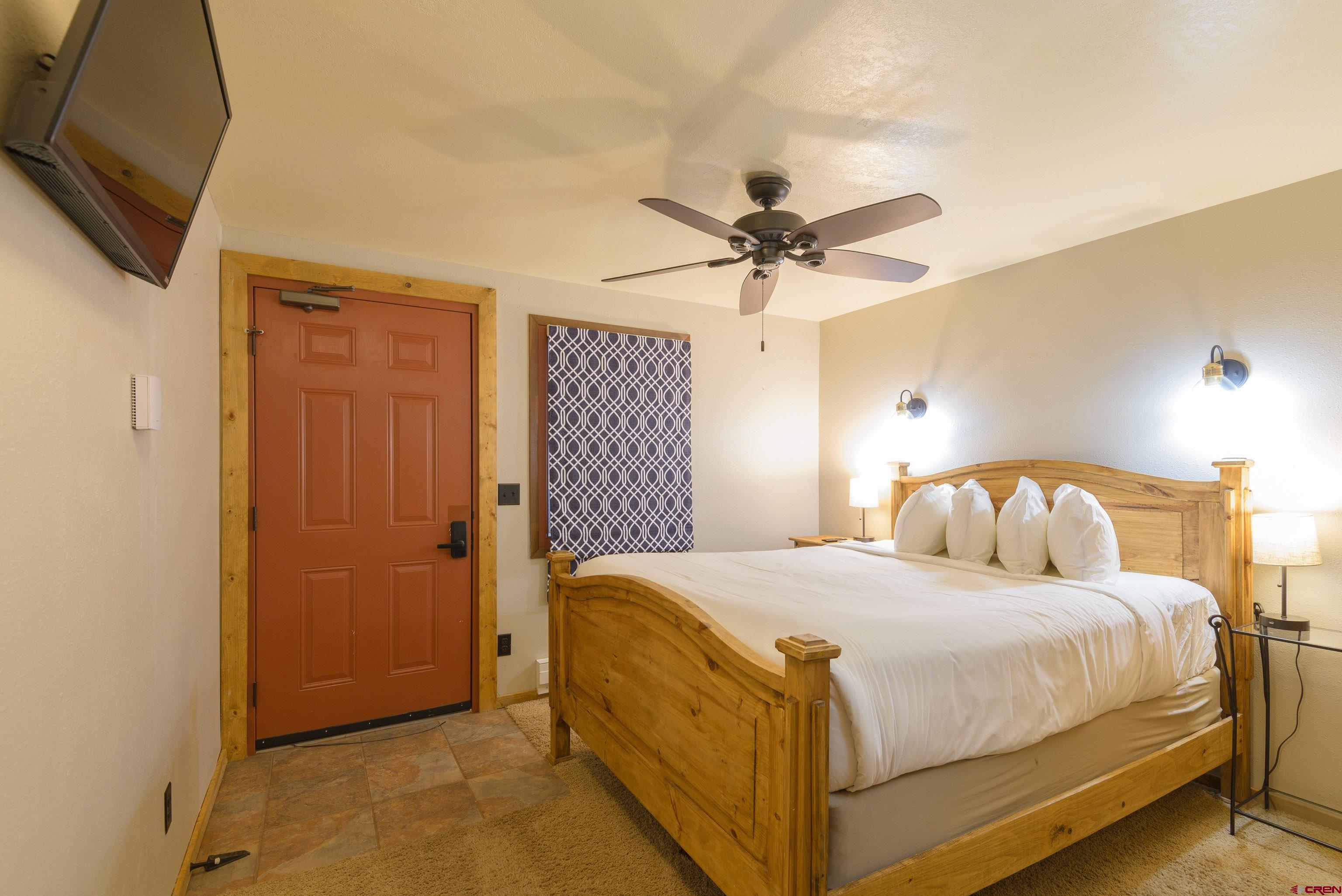 701 Gothic Road, Unit 306 Crested Butte, CO 81225 - Photo 12 of 25 a bedroom with a large bed a chandelier and closet