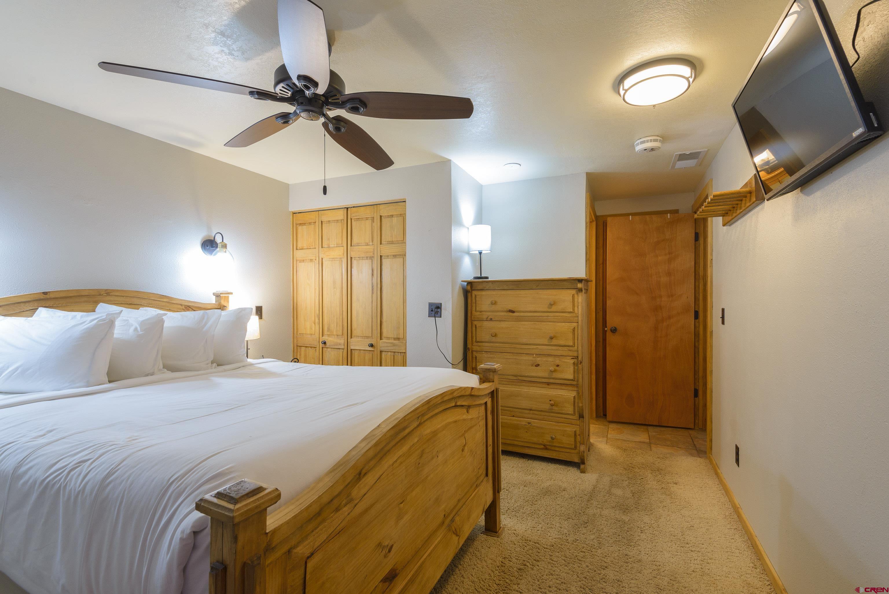 701 Gothic Road, Unit 306 Crested Butte, CO 81225 - Photo 13 of 25 a bedroom with a bed and a walk in closet