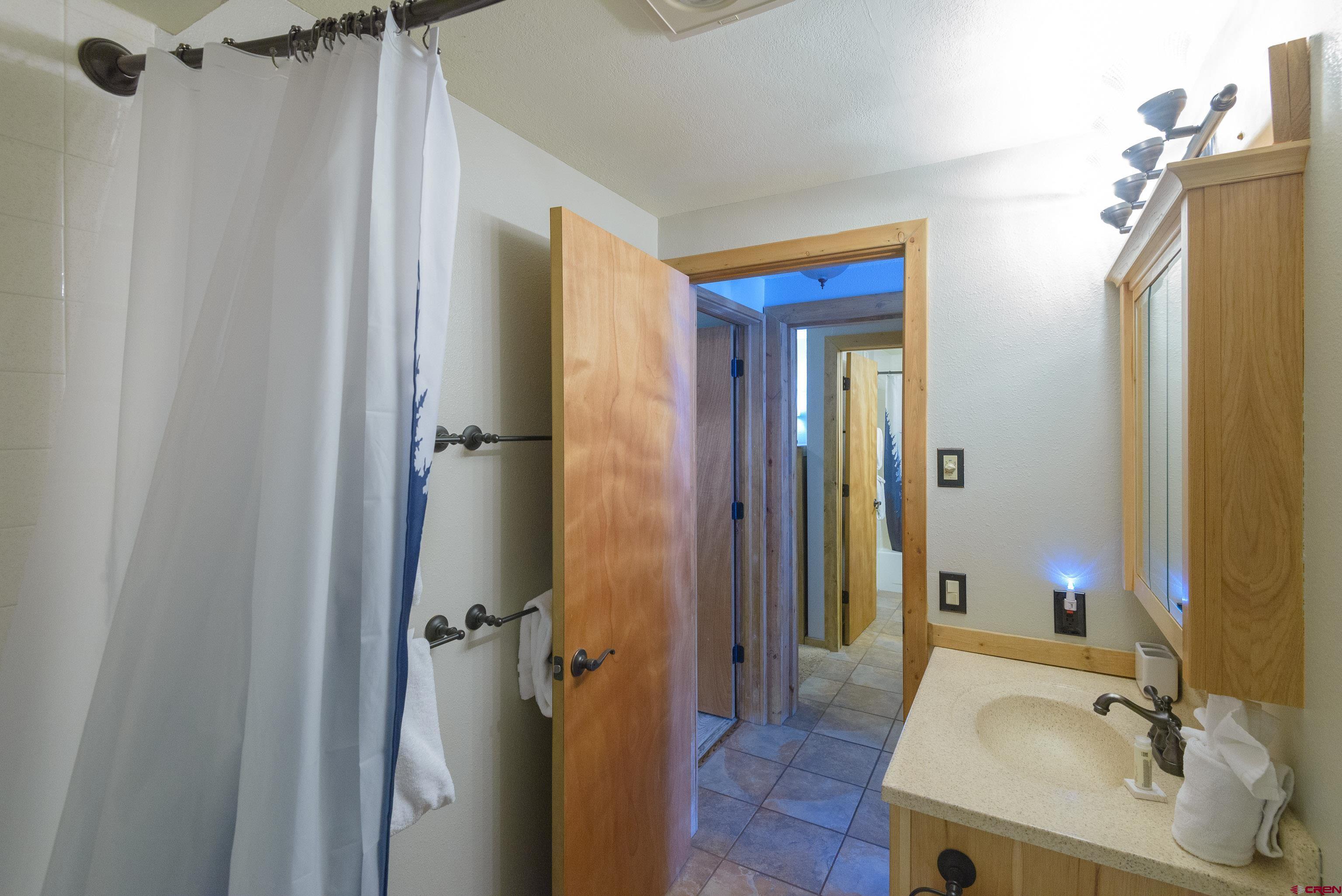 701 Gothic Road, Unit 306 Crested Butte, CO 81225 - Photo 14 of 25 a bathroom with a sink and shower