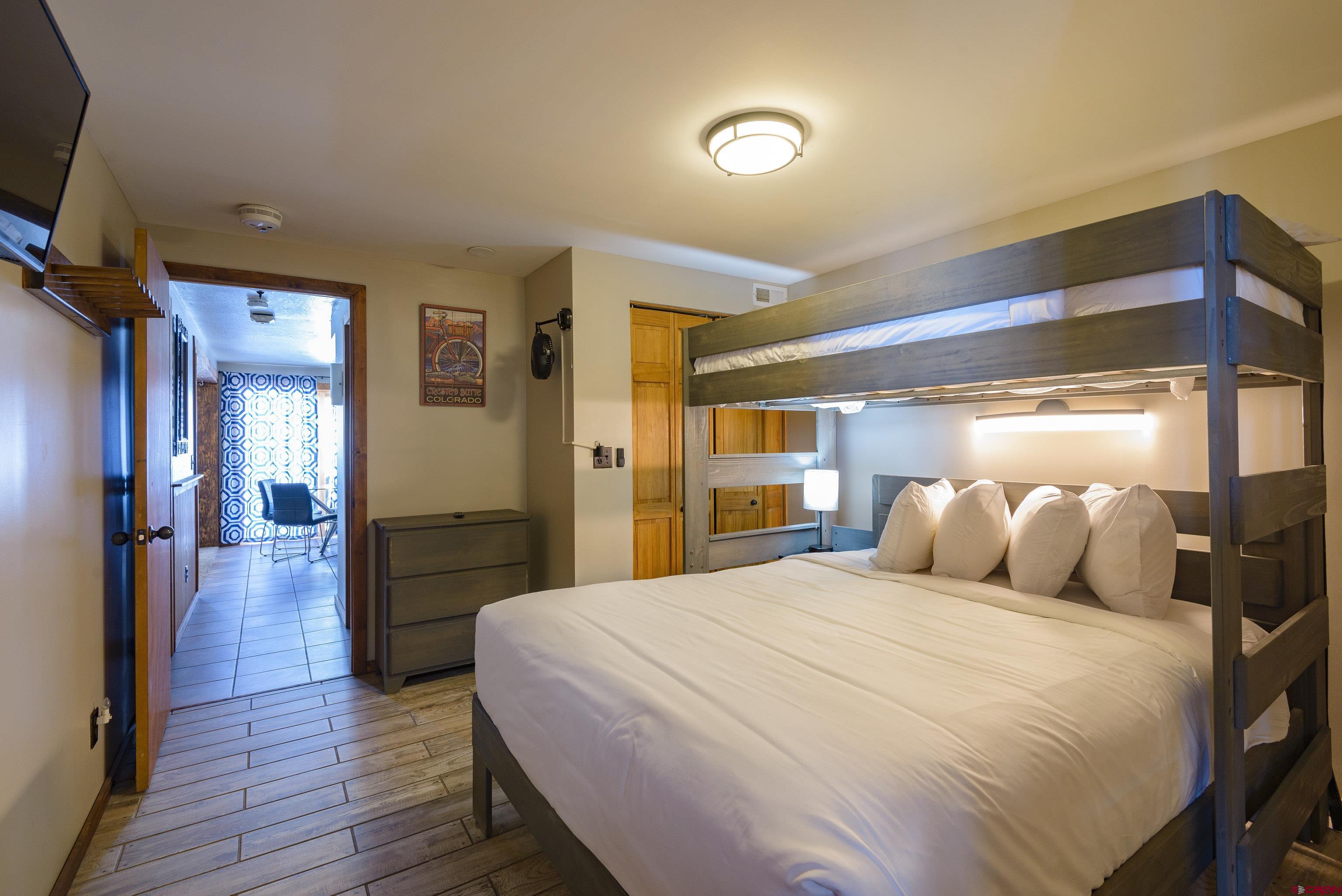 701 Gothic Road, Unit 306 Crested Butte, CO 81225 - Photo 10 of 25 a bedroom with a bed and a view of living room