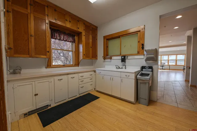 a kitchen with a sink cabinets appliances and a window
