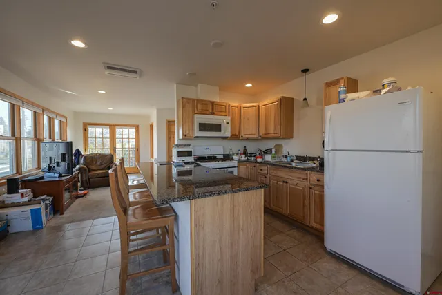 a kitchen with refrigerator a stove and a refrigerator