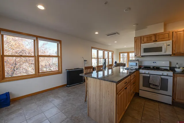a kitchen with stainless steel appliances granite countertop a stove and a sink