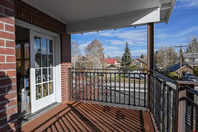 a view of a balcony with wooden floor