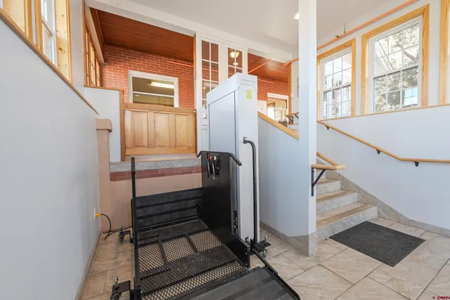 a view of staircase with wooden floor and a window