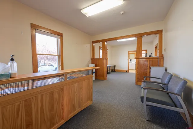 a living room with furniture and large windows