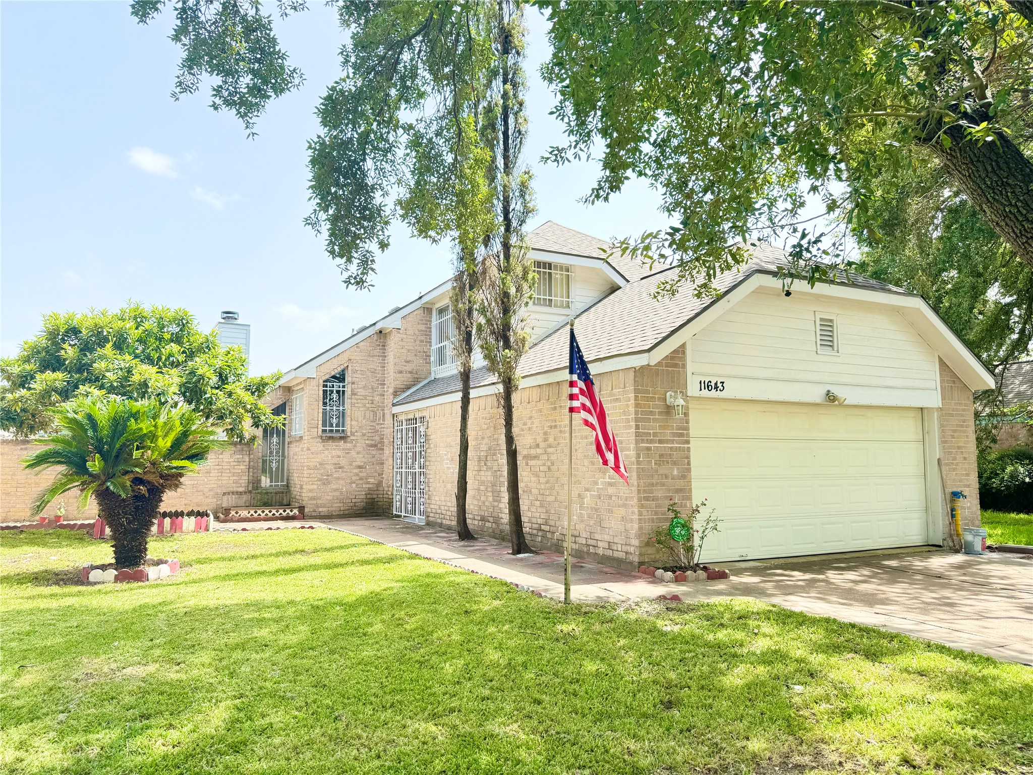 11643 Herald Square Drive Houston, TX 77099 - Photo 15 of 17 a front view of a house with a yard and garage