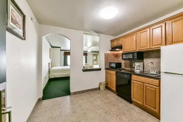 a kitchen with stainless steel appliances granite countertop a stove a refrigerator and a microwave