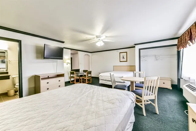 a spacious bedroom with a bed and a chandelier