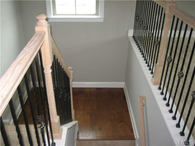2133 Lower Lake Road Wake Forest, NC 27587 - Photo 16 of 25 Staircase wood/with wrought iron spindles. We still have to stain the railing.