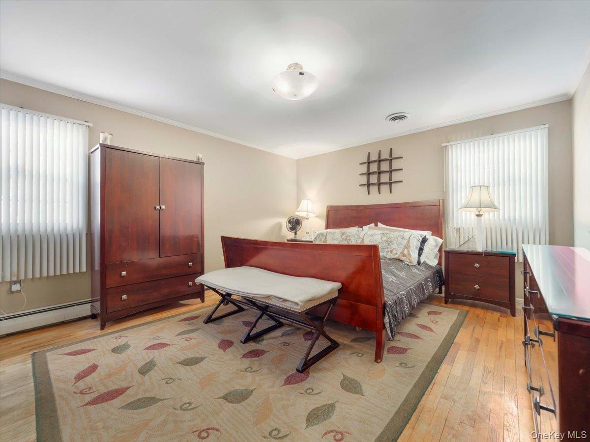 13 Razel Avenue Spring Valley, NY 10977 - Photo 20 of 43 a spacious bedroom with a bed and wooden floor