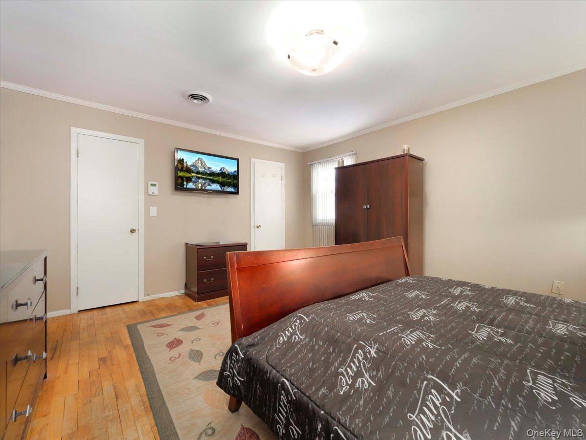 13 Razel Avenue Spring Valley, NY 10977 - Photo 22 of 43 a bedroom with a bed and a flat screen tv