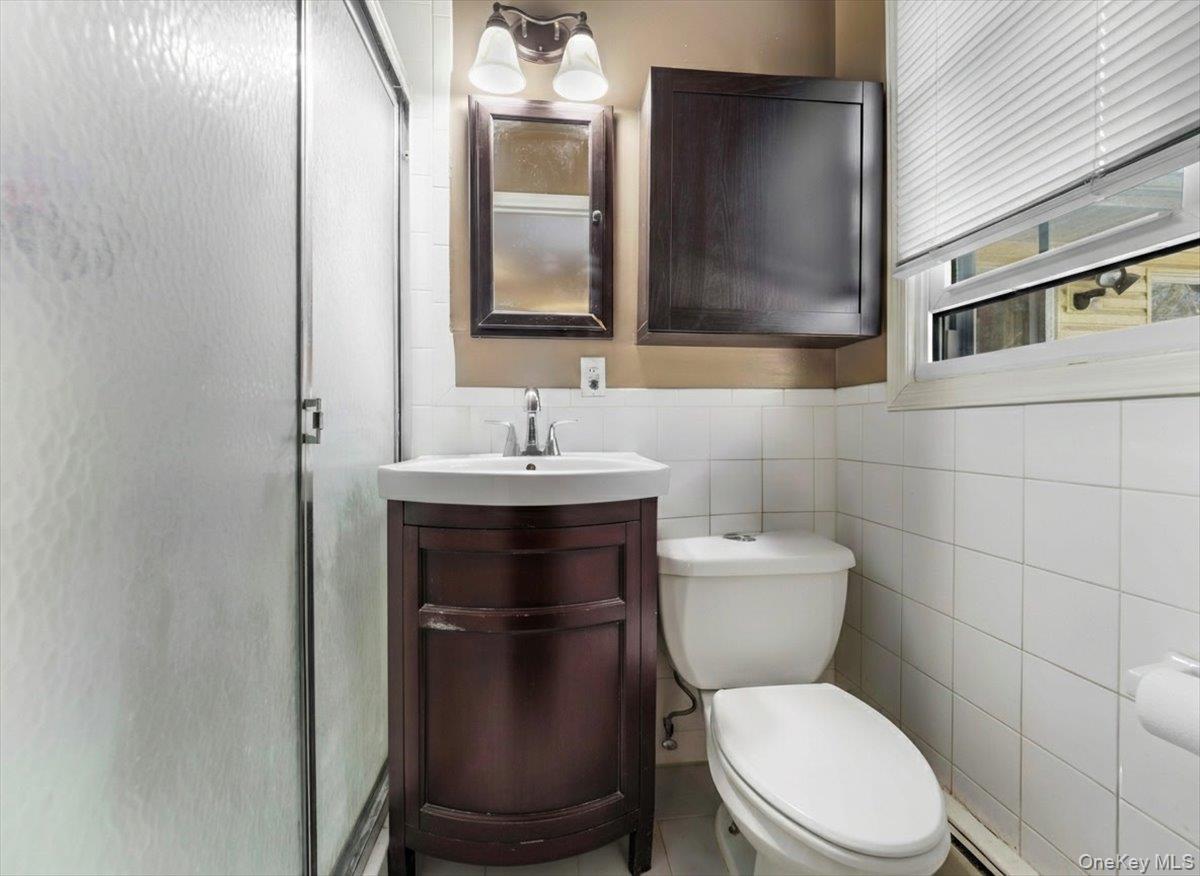 13 Razel Avenue Spring Valley, NY 10977 - Photo 23 of 43 a bathroom with a toilet sink and mirror