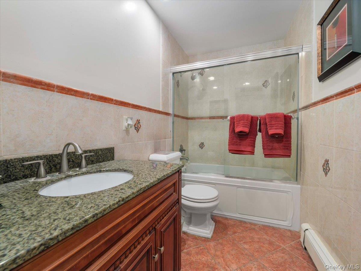 13 Razel Avenue Spring Valley, NY 10977 - Photo 28 of 43 a bathroom with a granite countertop sink a toilet and shower