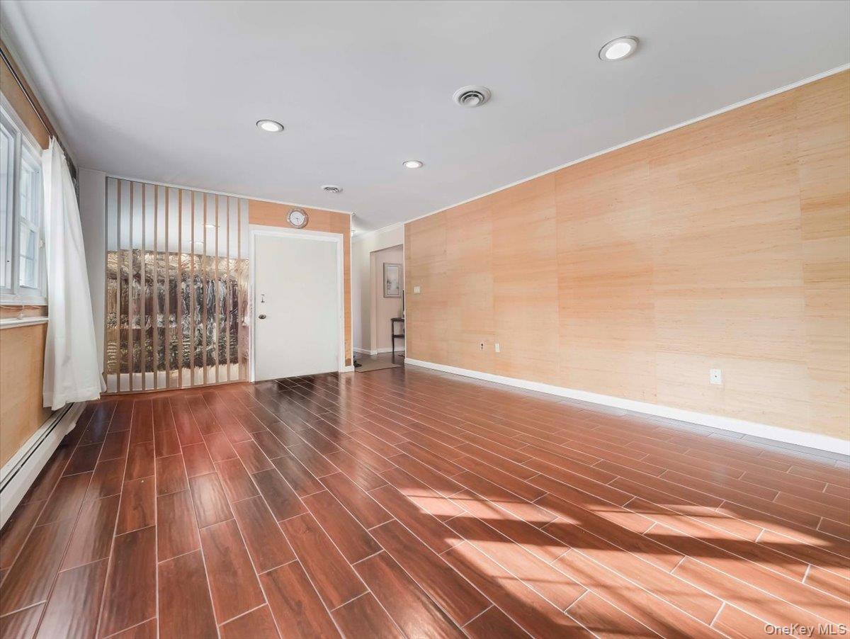 13 Razel Avenue Spring Valley, NY 10977 - Photo 31 of 43 an empty room with wooden floor and windows