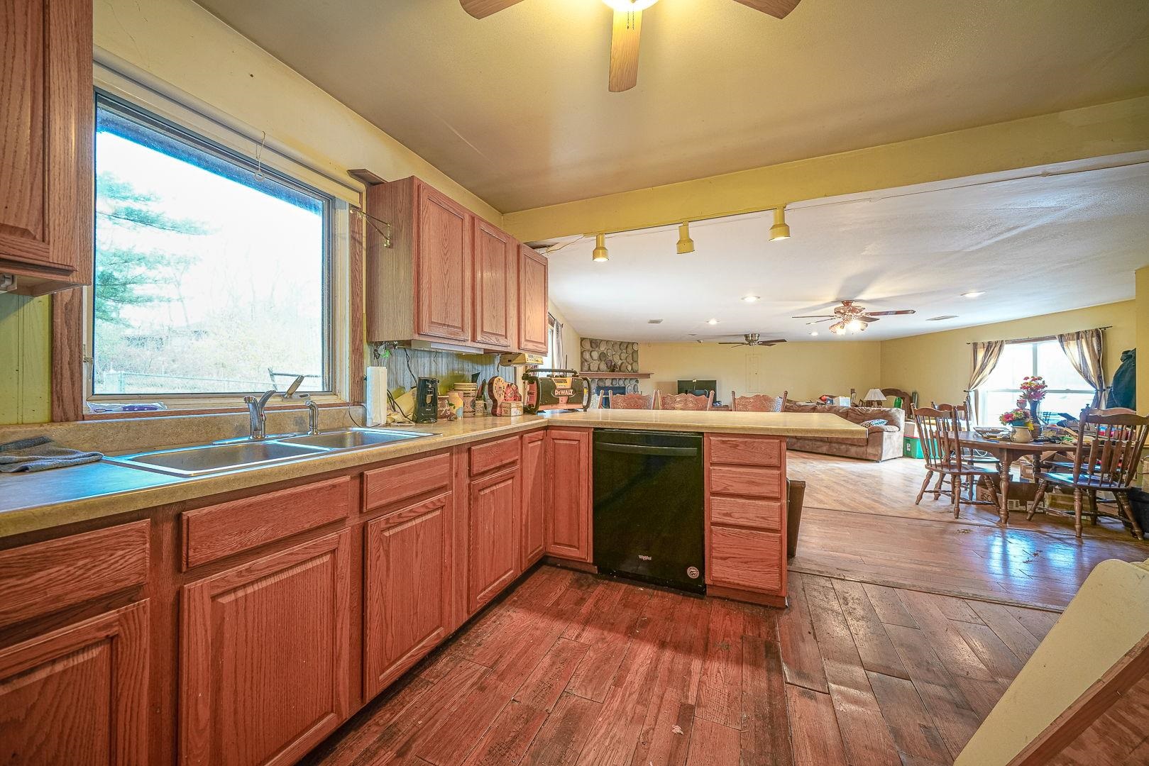8330 North Kishwaukee Road Stillman Valley, IL 61084 - Photo 11 of 37 a kitchen with stainless steel appliances granite countertop sink stove top oven and cabinets