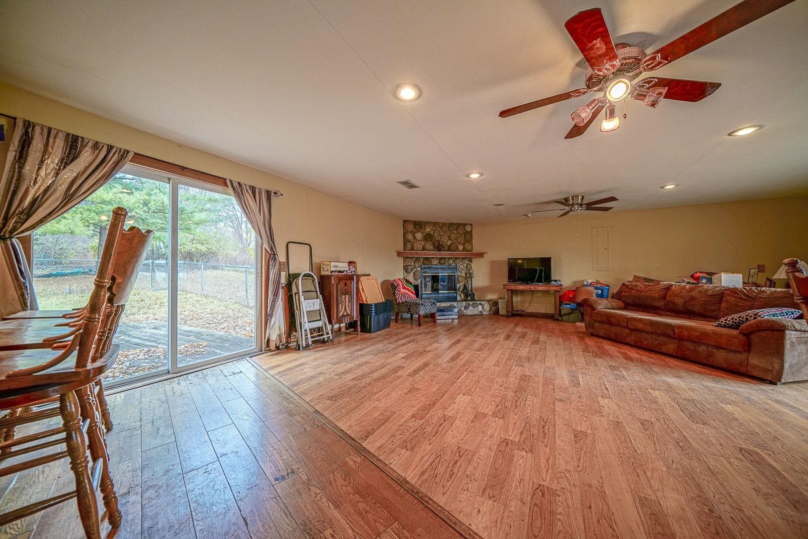 8330 North Kishwaukee Road Stillman Valley, IL 61084 - Photo 12 of 37 a living room with furniture and a large window