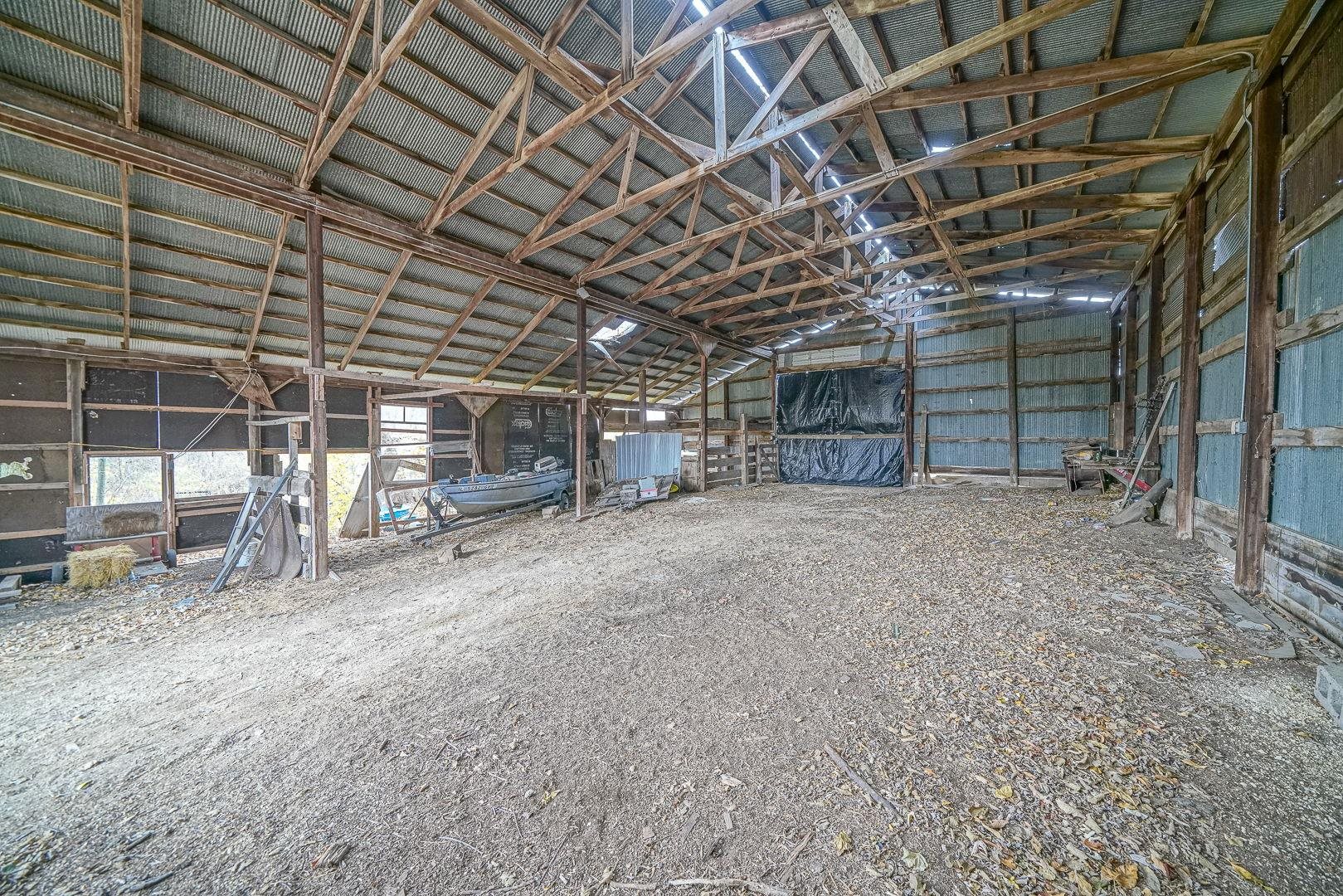 8330 North Kishwaukee Road Stillman Valley, IL 61084 - Photo 6 of 37 a view of an empty room with wooden walls