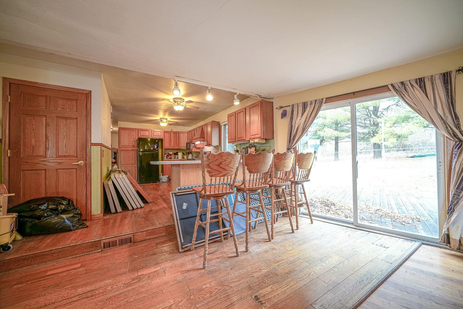 8330 North Kishwaukee Road Stillman Valley, IL 61084 - Photo 10 of 37 a dining room with furniture water view and a floor to ceiling window