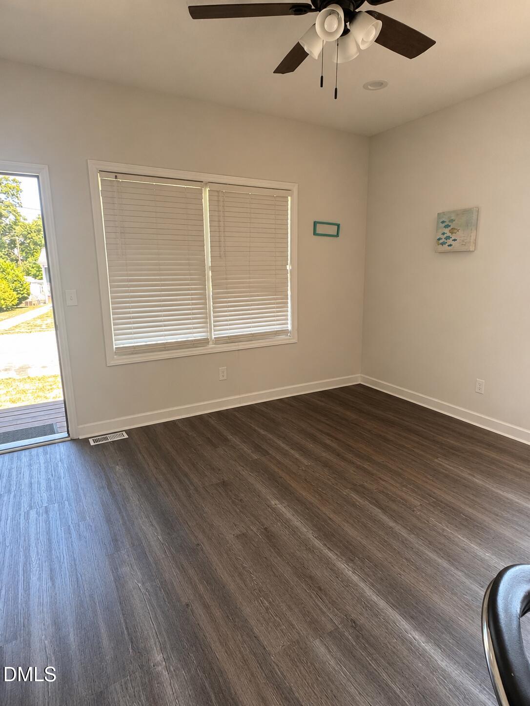 1003 Alma Street, Unit B Durham, NC 27703 - Photo 2 of 5 a view of an empty room with wooden floor and a window