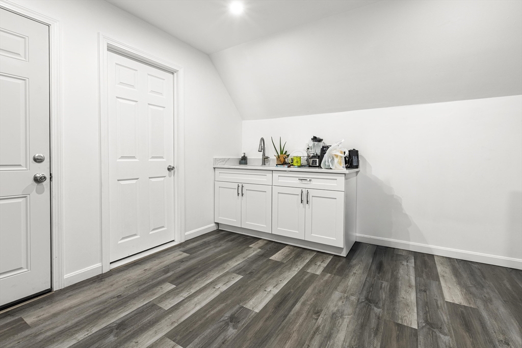 139-141 Foster Street Lawrence, MA 01843 - Photo 11 of 16 a view of a kitchen with wooden floor and cabinets