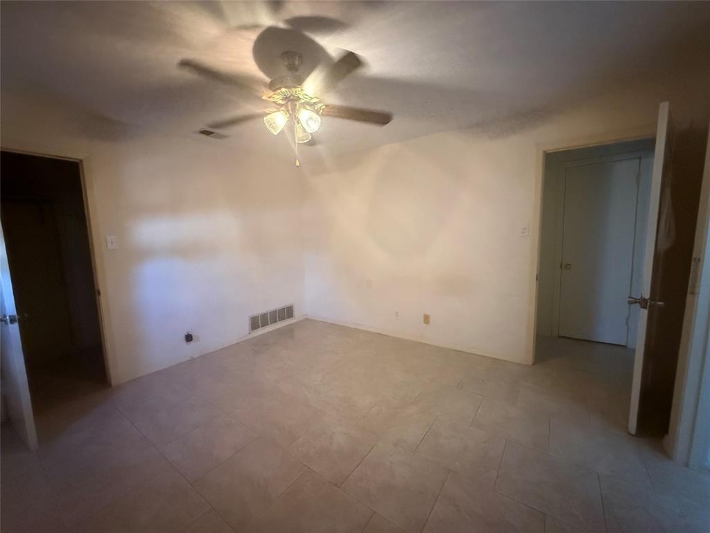 13329 Southview Lane Dallas, TX 75240 - Photo 15 of 17 an empty room with a fan & a window