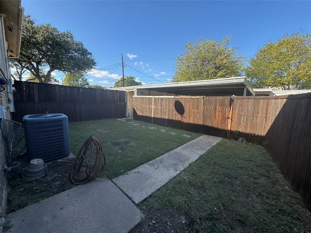 a view of a backyard with wooden fence