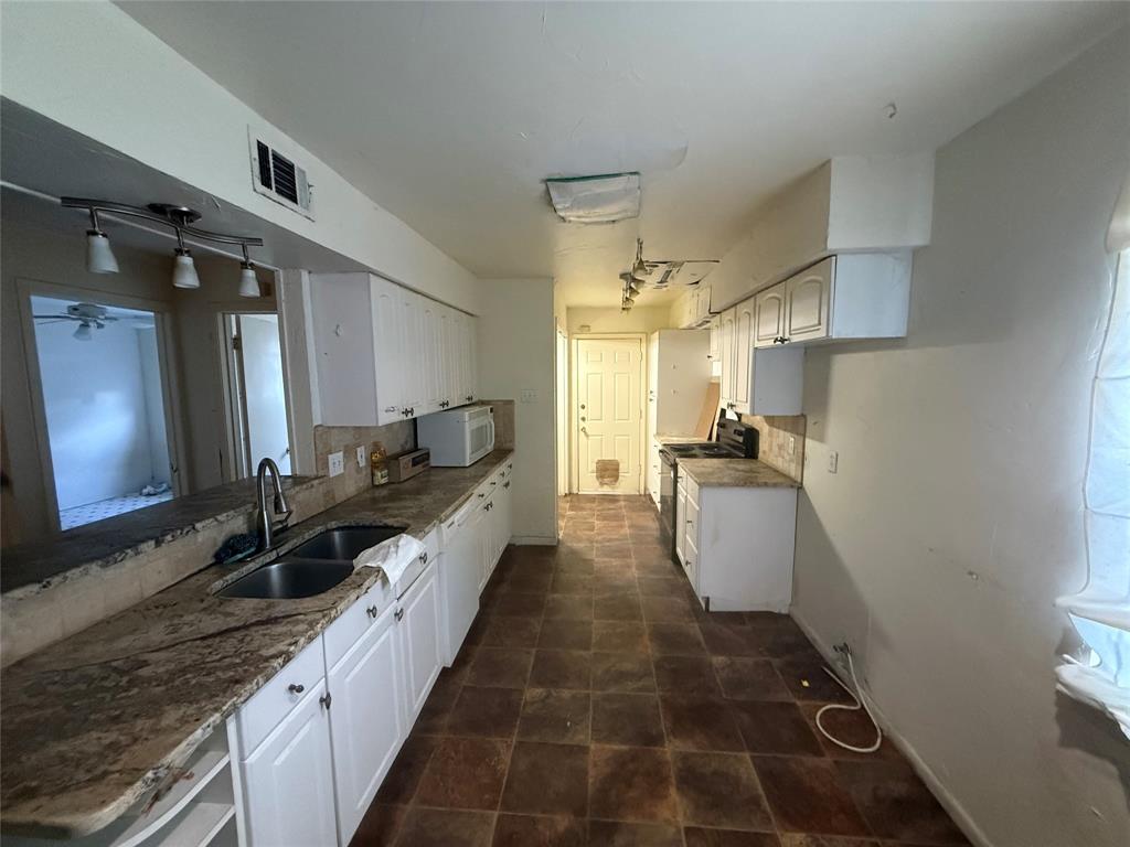 13329 Southview Lane Dallas, TX 75240 - Photo 8 of 17 a large kitchen with a sink and stainless steel appliances