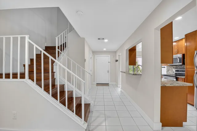 a view of a hallway with wooden floor and dining room