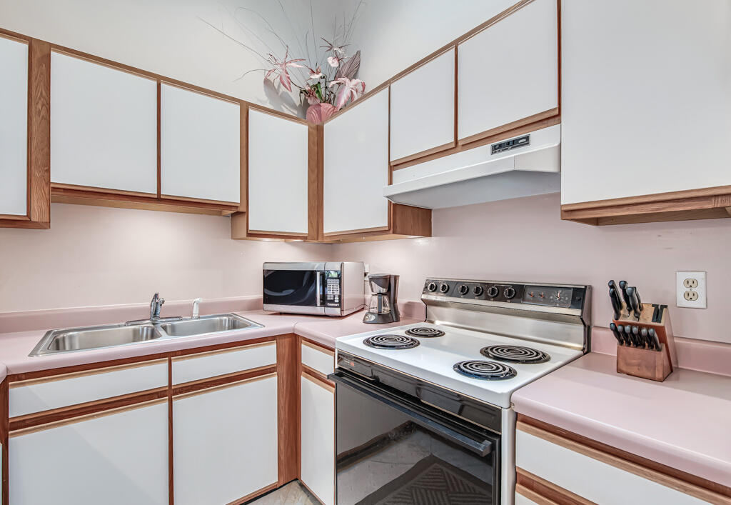 815 Andrew Redding Road, Unit 202 Lantana, FL 33462 - Photo 13 of 30 a kitchen with a stove cabinets and a sink