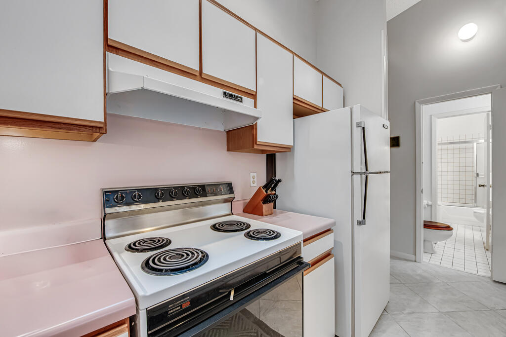 815 Andrew Redding Road, Unit 202 Lantana, FL 33462 - Photo 15 of 30 a kitchen with a stove and a refrigerator