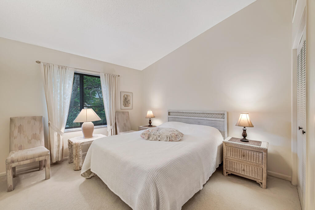 815 Andrew Redding Road, Unit 202 Lantana, FL 33462 - Photo 16 of 30 a bedroom with a bed and a lamp