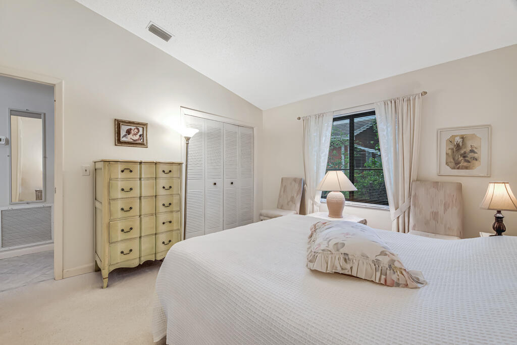 815 Andrew Redding Road, Unit 202 Lantana, FL 33462 - Photo 17 of 30 a bedroom with a bed a dresser and a window