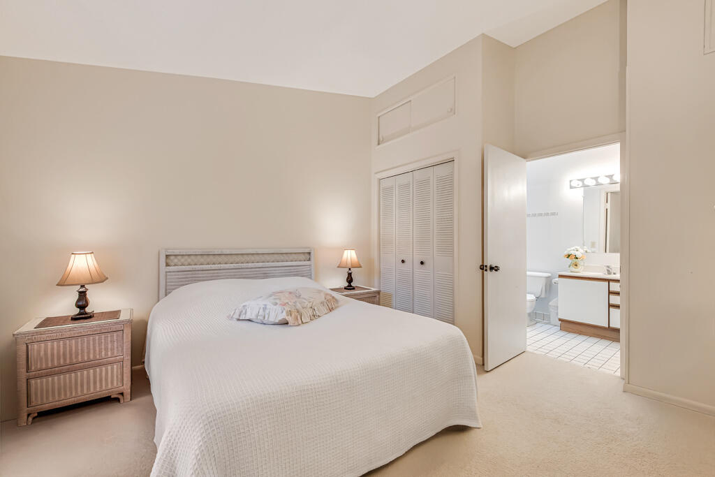 815 Andrew Redding Road, Unit 202 Lantana, FL 33462 - Photo 18 of 30 a bedroom with a bed and a lamp