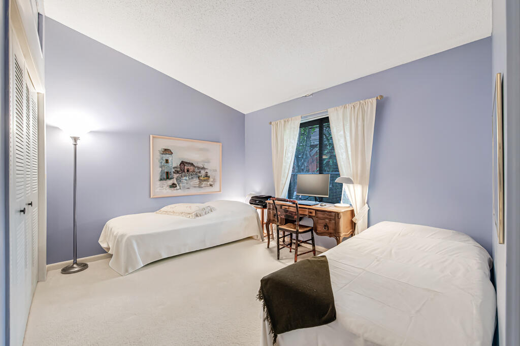 815 Andrew Redding Road, Unit 202 Lantana, FL 33462 - Photo 20 of 30 a bedroom with a bed and a table