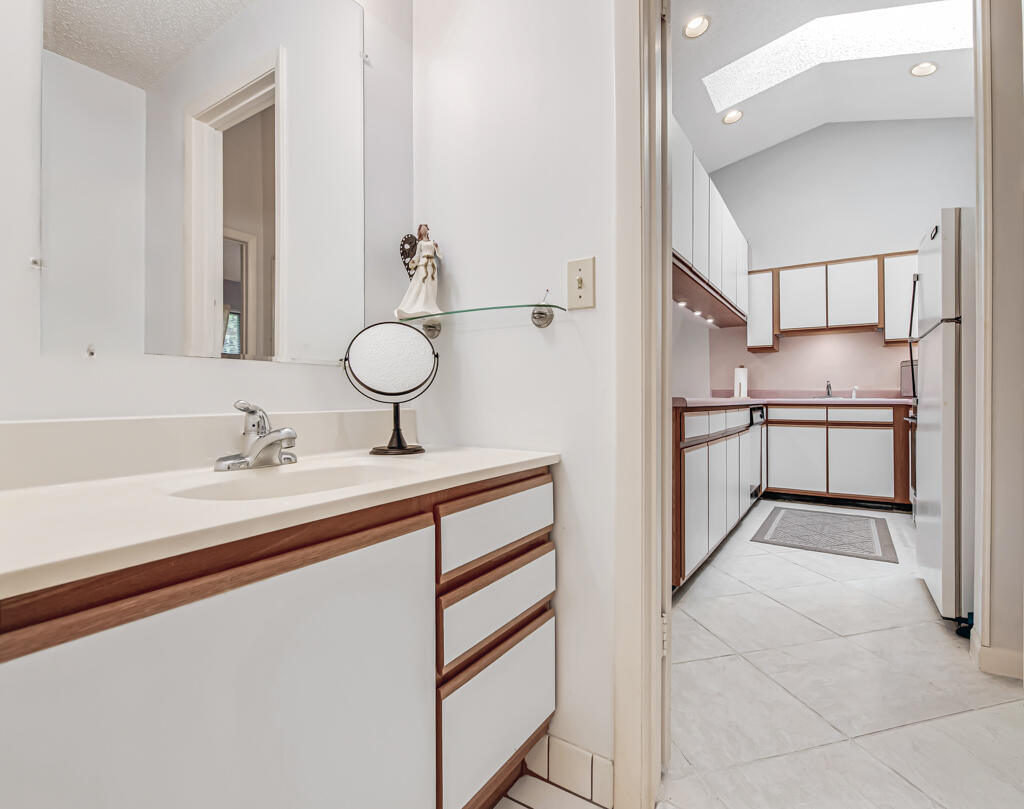 815 Andrew Redding Road, Unit 202 Lantana, FL 33462 - Photo 22 of 30 a bathroom with a sink and a mirror