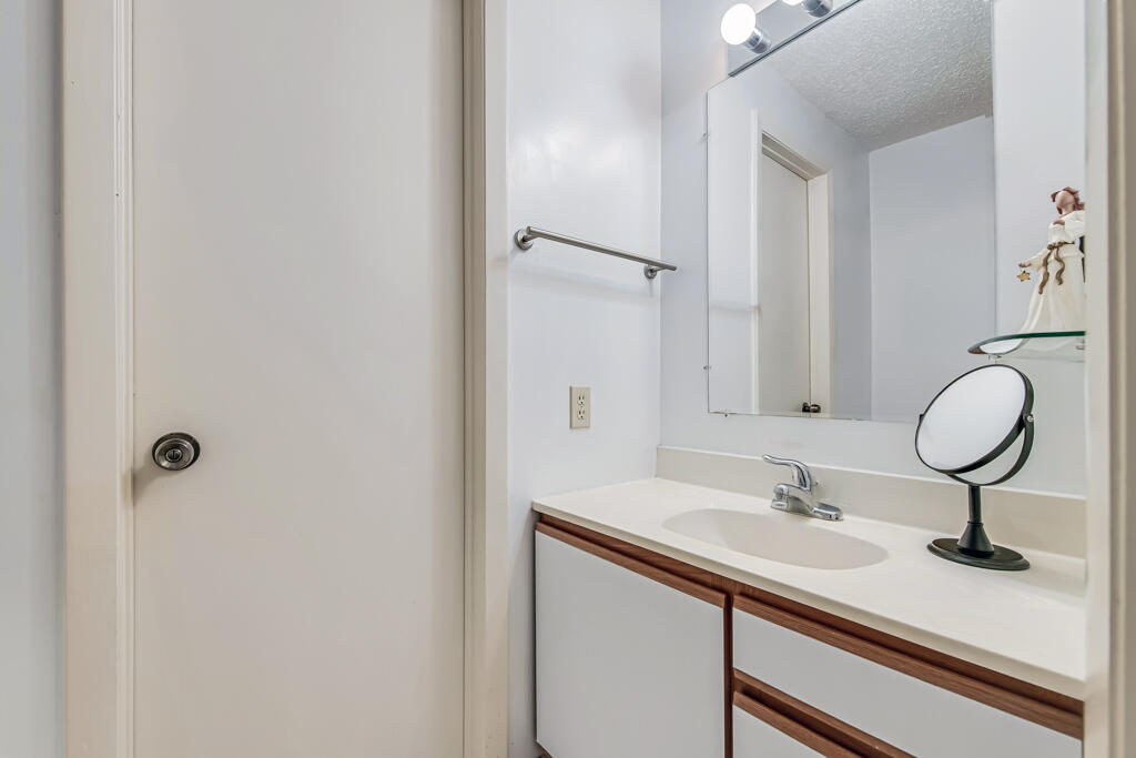 815 Andrew Redding Road, Unit 202 Lantana, FL 33462 - Photo 24 of 30 a bathroom with a sink and a mirror