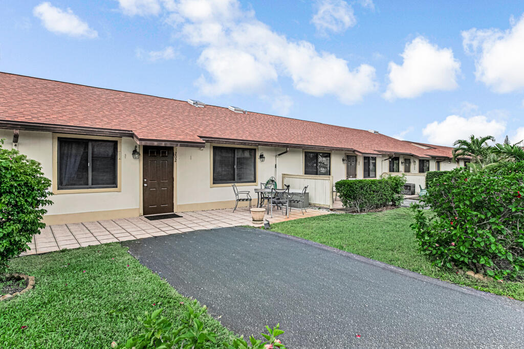 815 Andrew Redding Road, Unit 202 Lantana, FL 33462 - Photo 28 of 30 a front view of a house with yard patio and green space