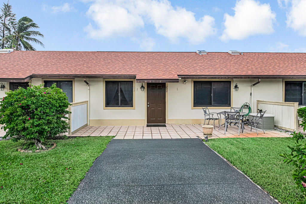 815 Andrew Redding Road, Unit 202 Lantana, FL 33462 - Photo 30 of 30 a front view of house with yard and seating area