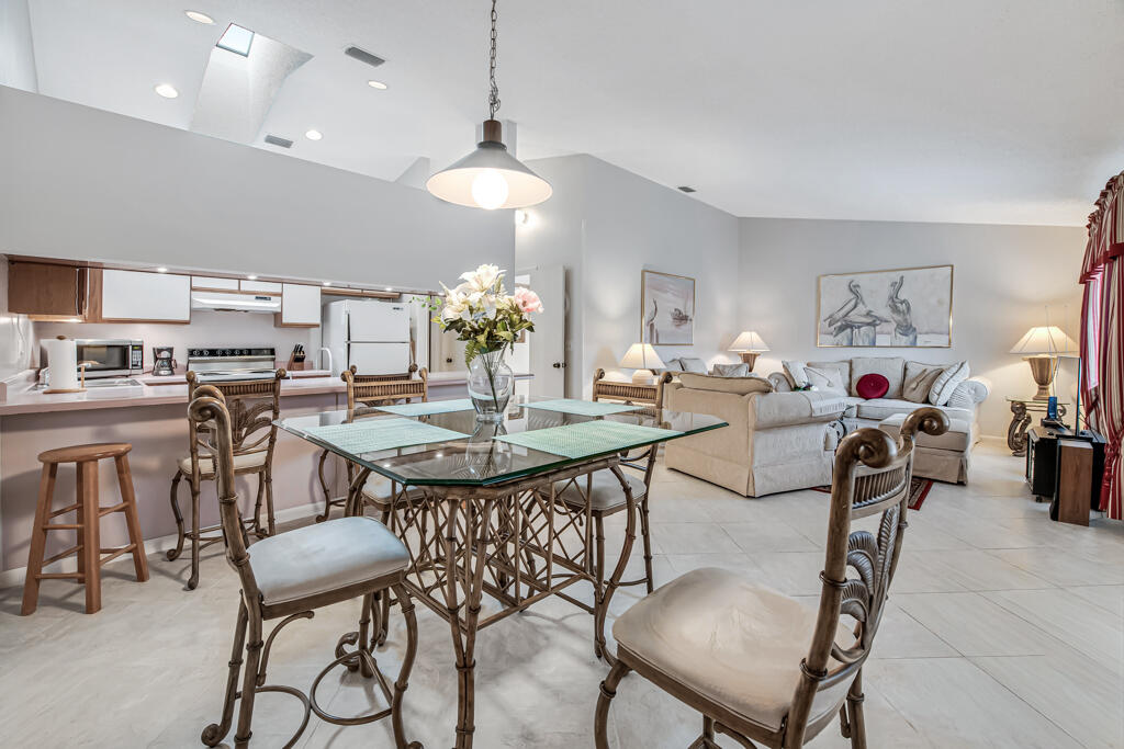 815 Andrew Redding Road, Unit 202 Lantana, FL 33462 - Photo 4 of 30 a view of a dining room with furniture and a chandelier