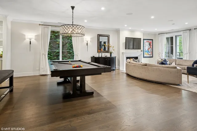 a living room with fireplace furniture and a chandelier