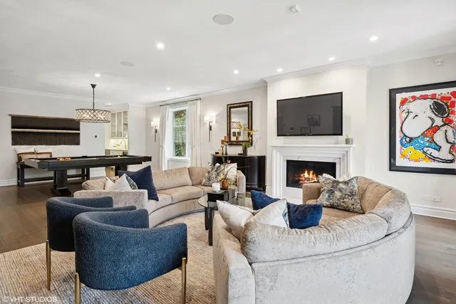 a living room with furniture fireplace and flat screen tv